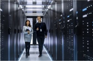 Man and woman walking through a data center