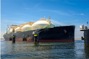 Large ship tethered to posts in the ocean