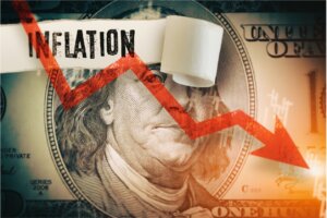 100 dollar bill with inflation and a downward arrow