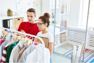 Man and woman looking at clothing rack