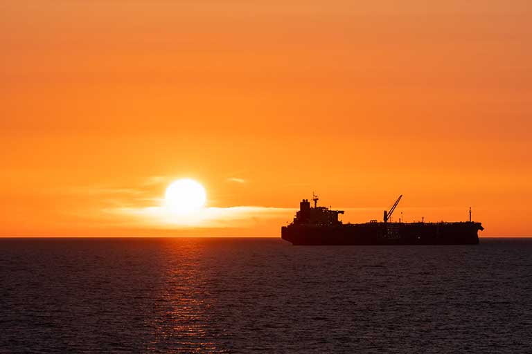 Gas Fuel Tanker Ship Sailing In The Sunset